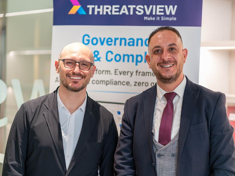 Networking beside the Governance, Risk and Compliance stand.